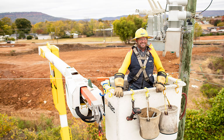 EPB Employee helping customer around an air conditioner unit